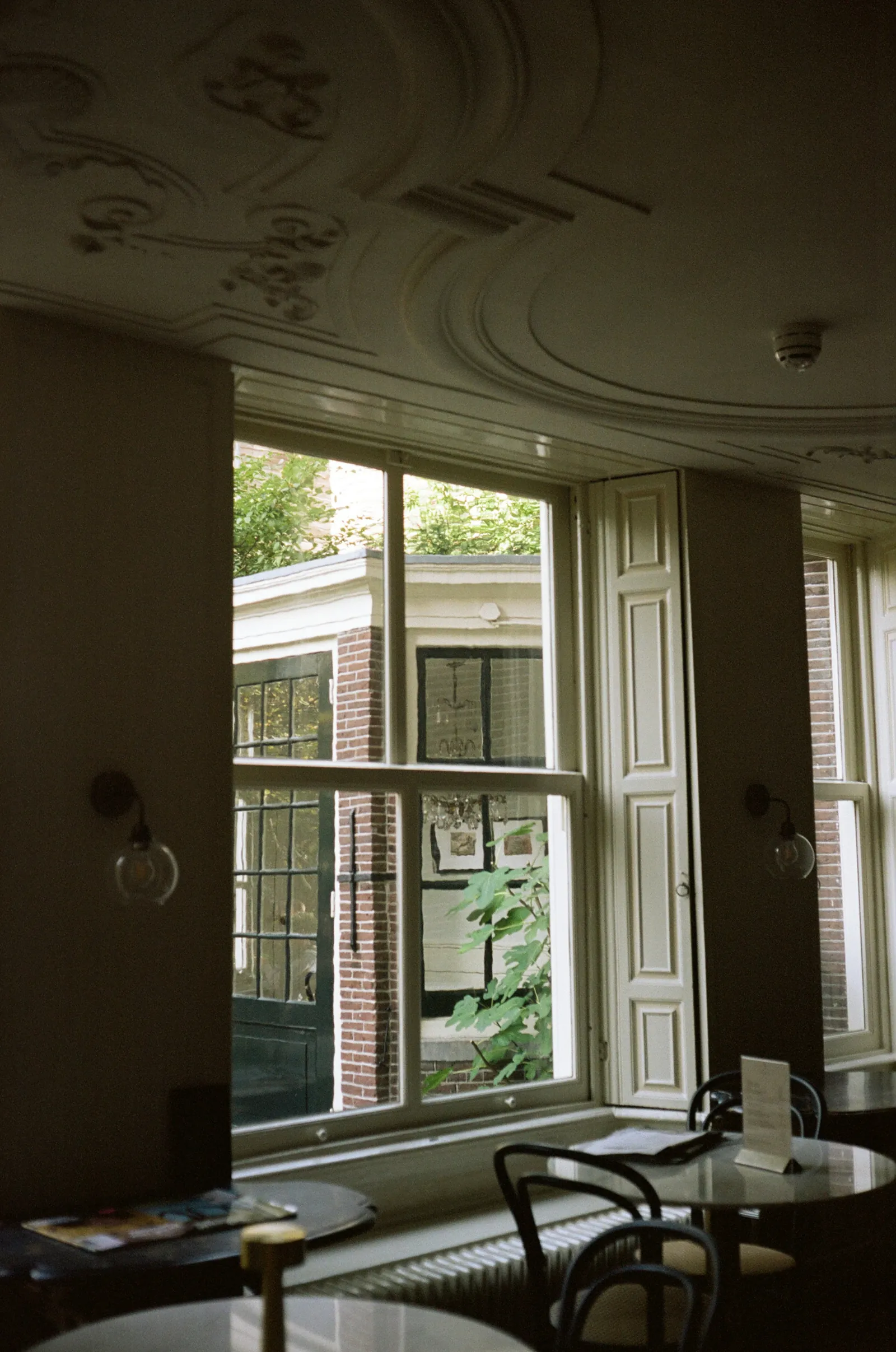A Georgian room with tall sash windows and a plaster cornice