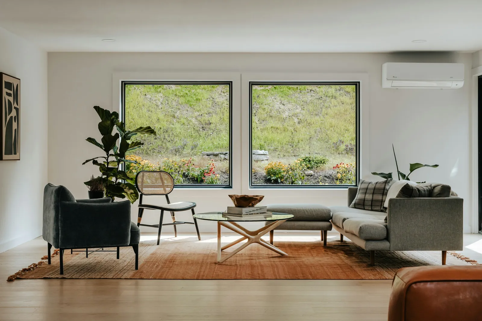 Living room with two large windows onto the hillside