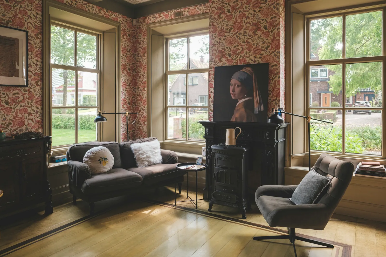A loft room with big windows and a wood-burning stove