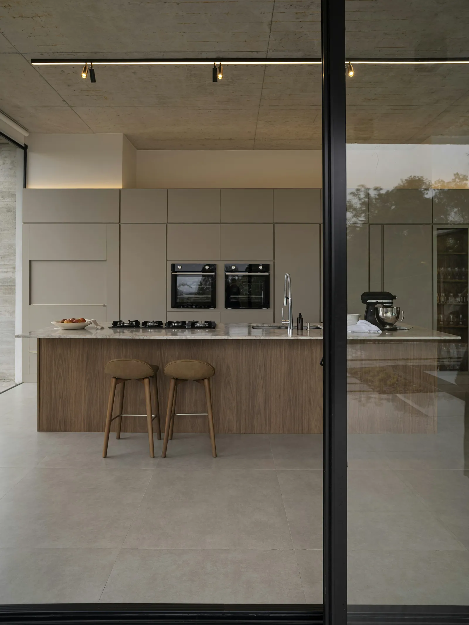 A kitchen with a glazed wall onto the garden