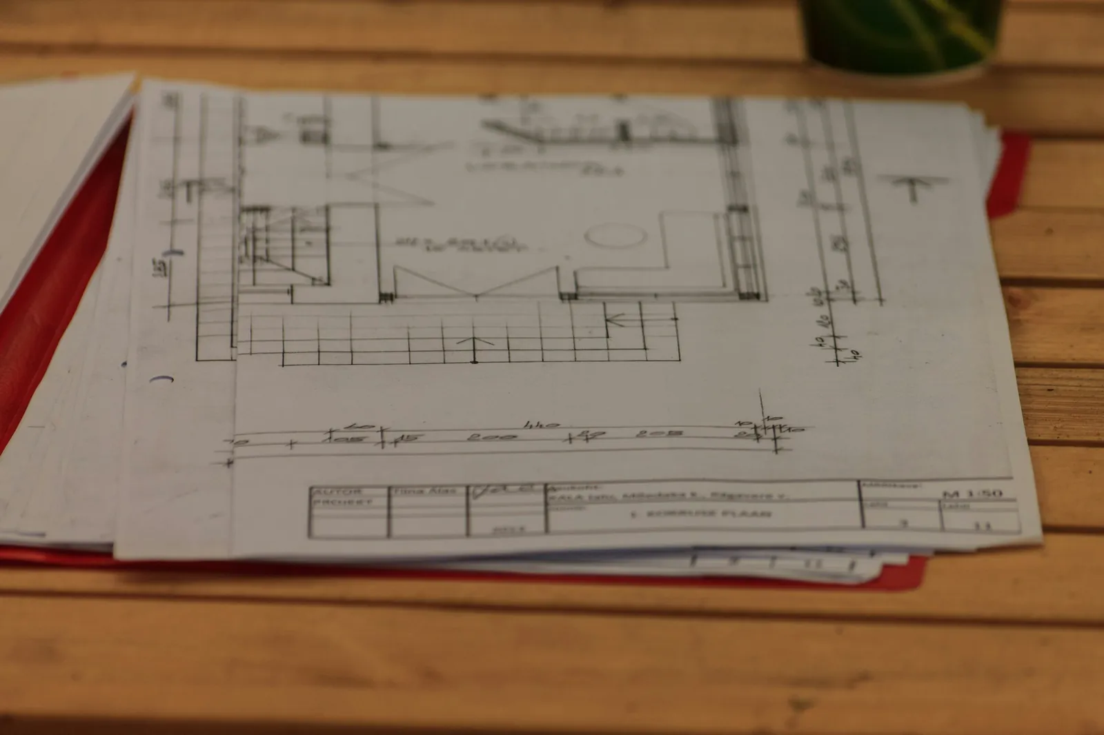 Construction drawings spread across a timber table