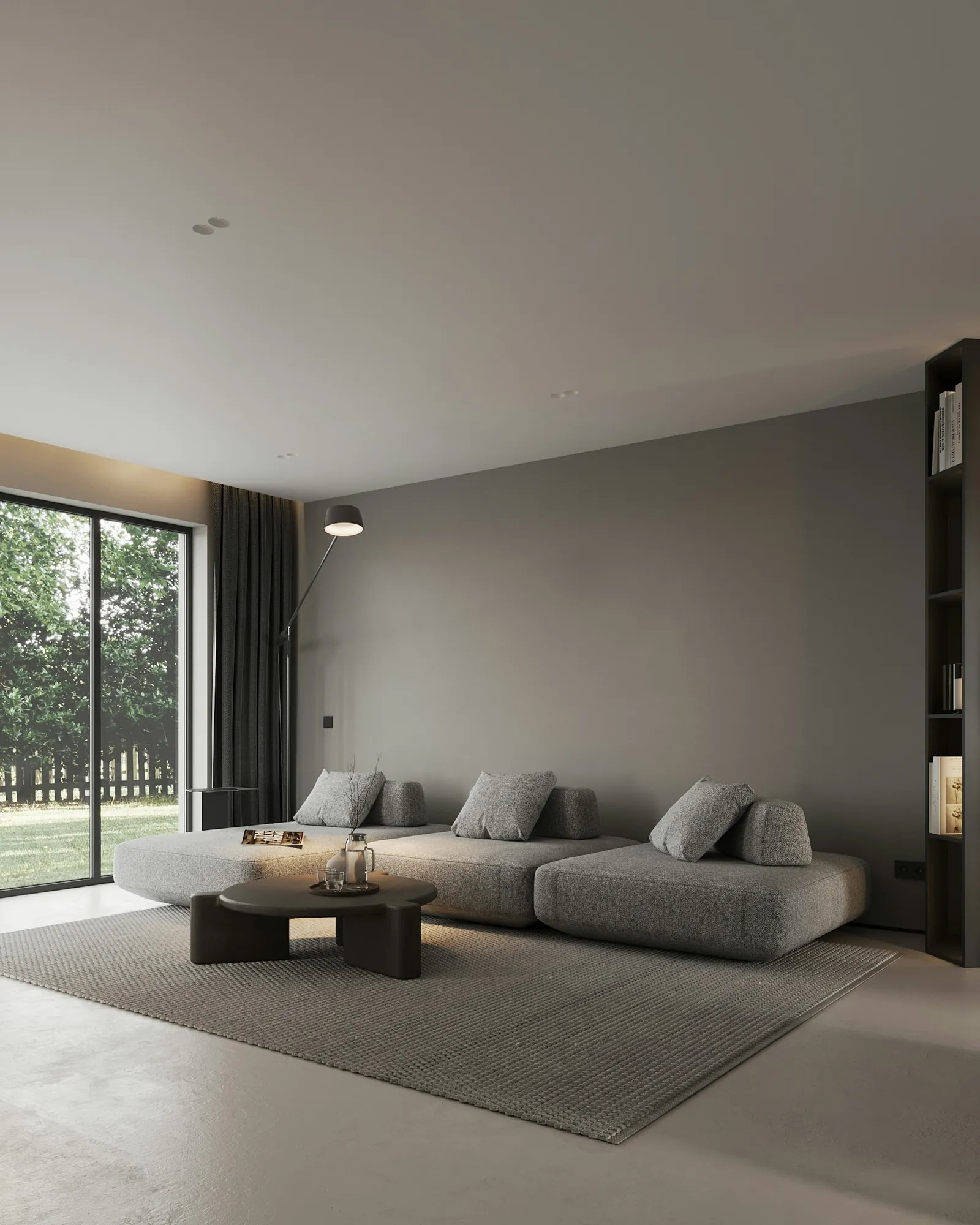 A grey living room with a glazed wall onto the garden
