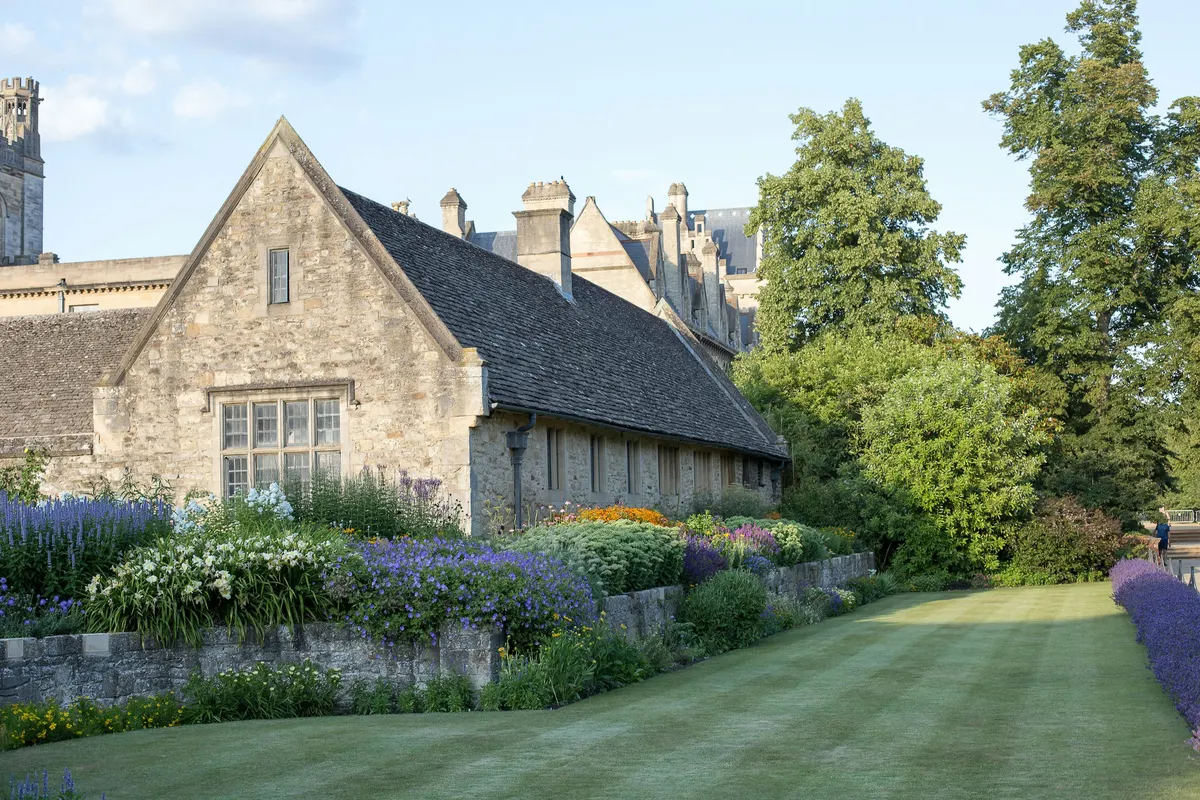 A stone house behind a border of lavender