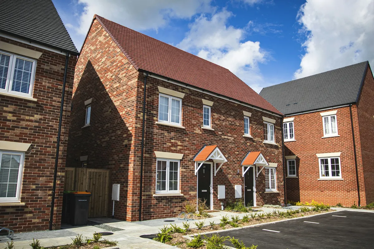 A short row of new red-brick houses with grey roofs