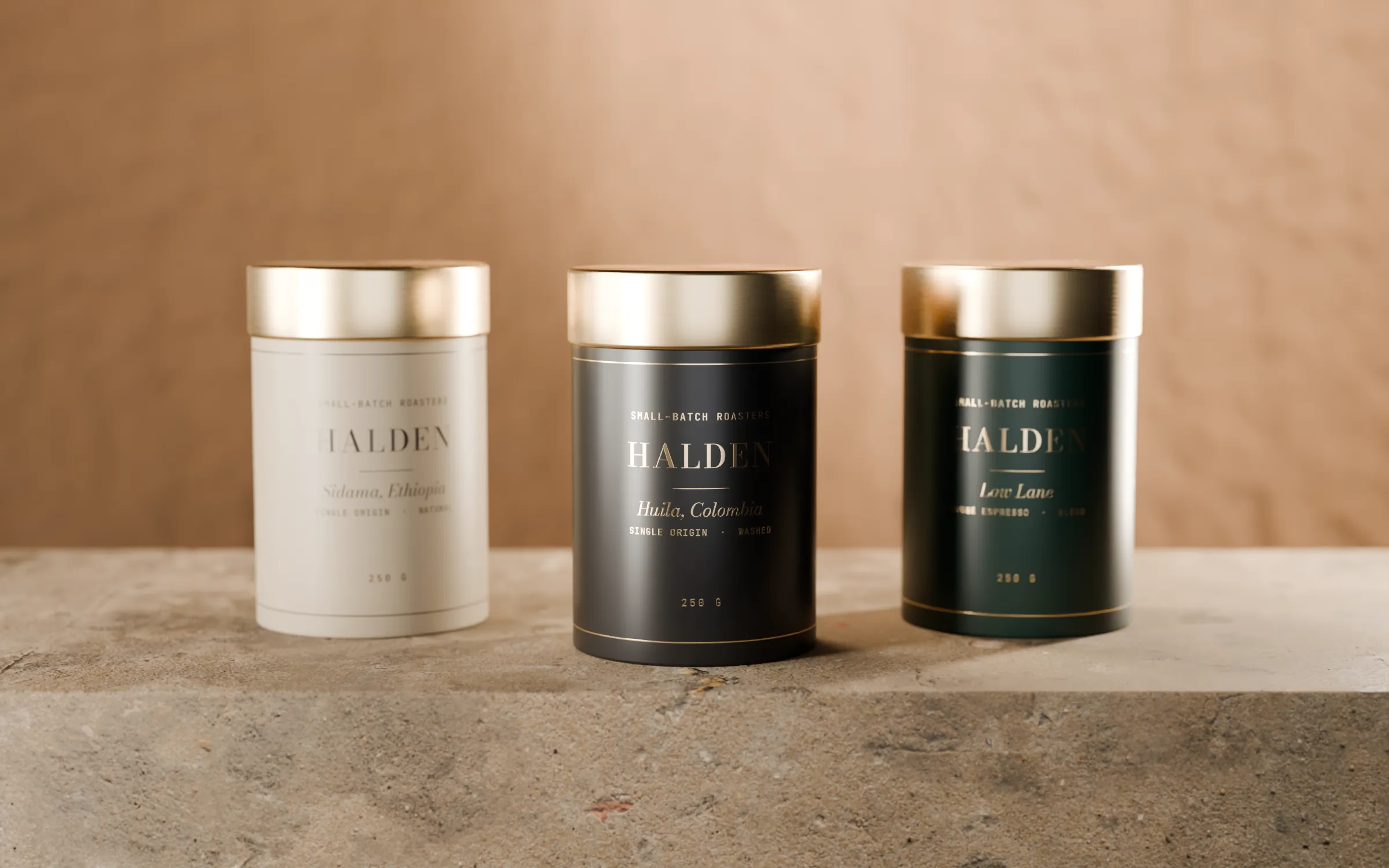 The three Halden tins together: Sidama in cream, Huila in black, Low Lane in green