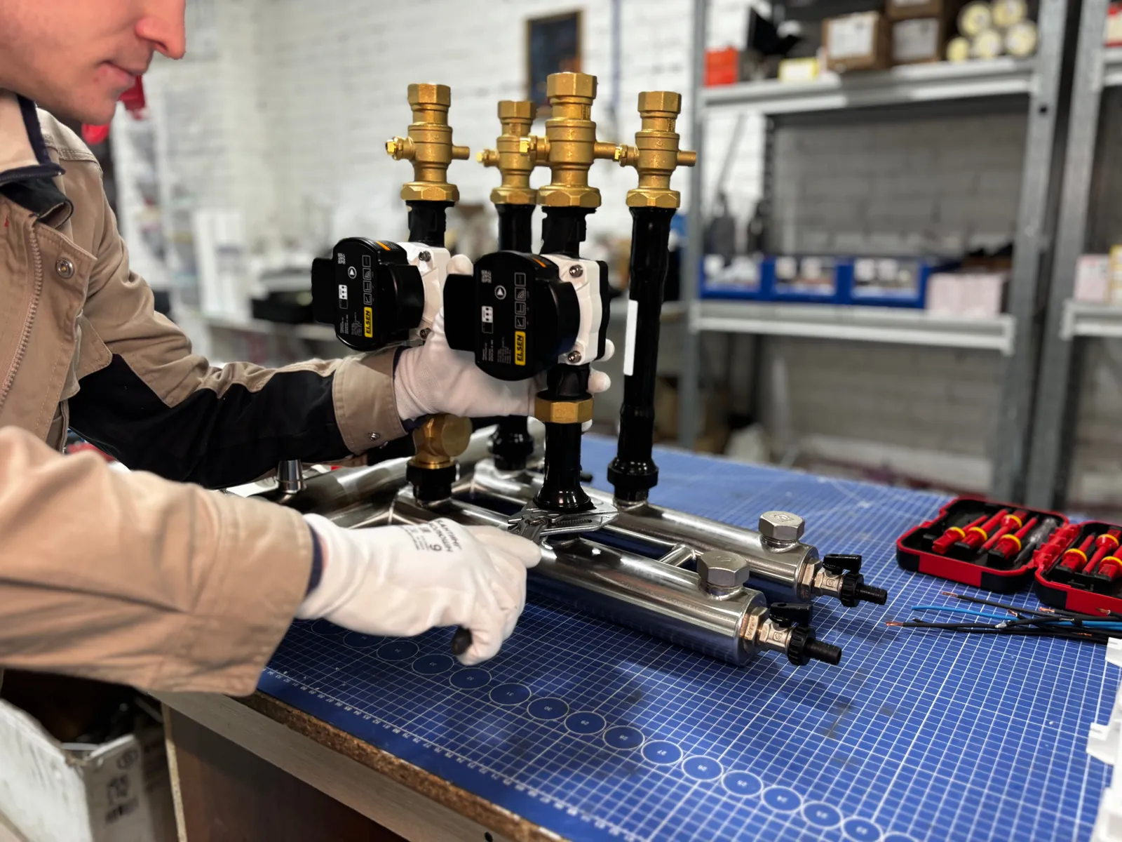 Brass manifold and pump assembled on a workbench