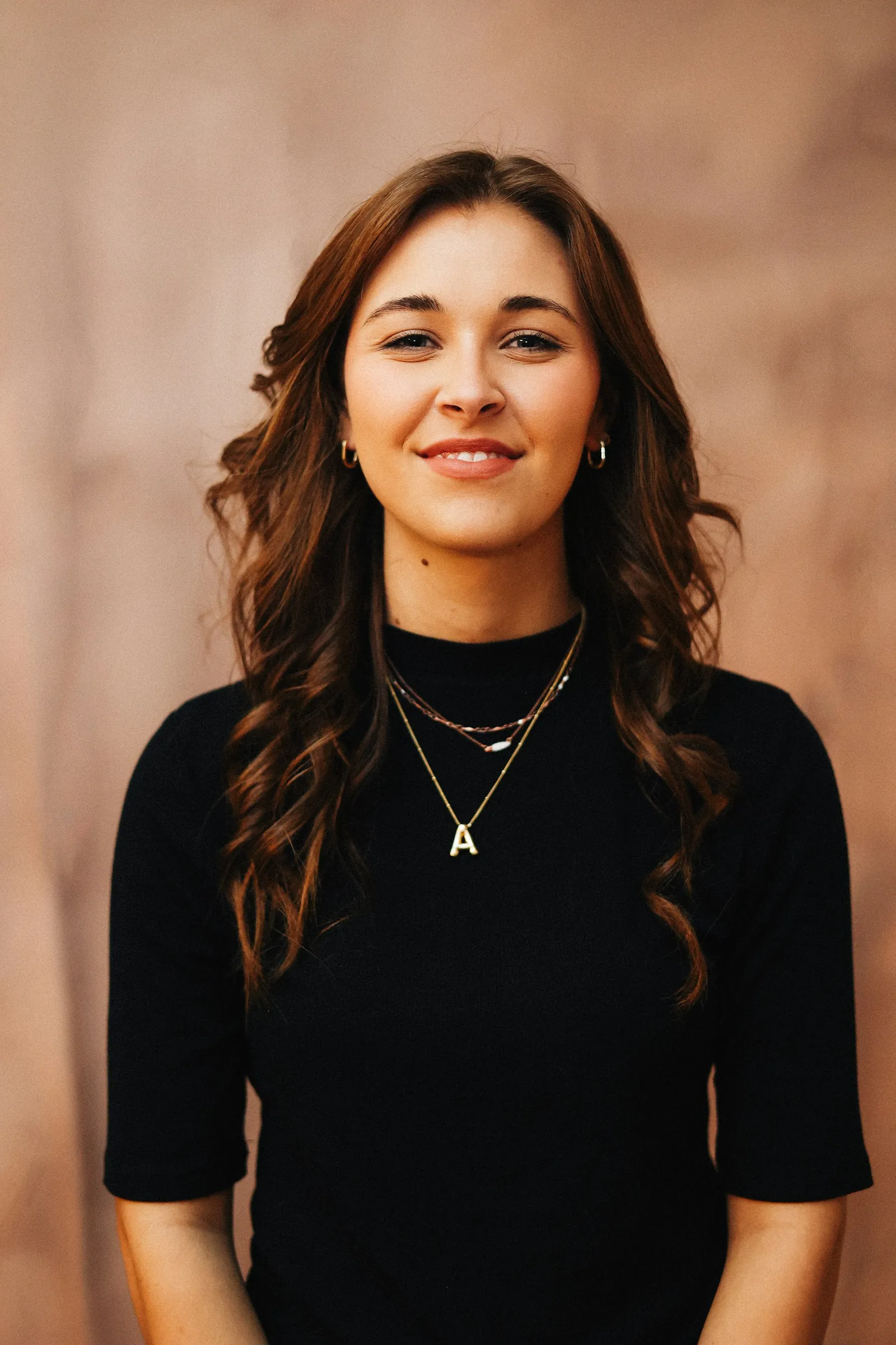 Hannah Cole, photographed against a warm plain background