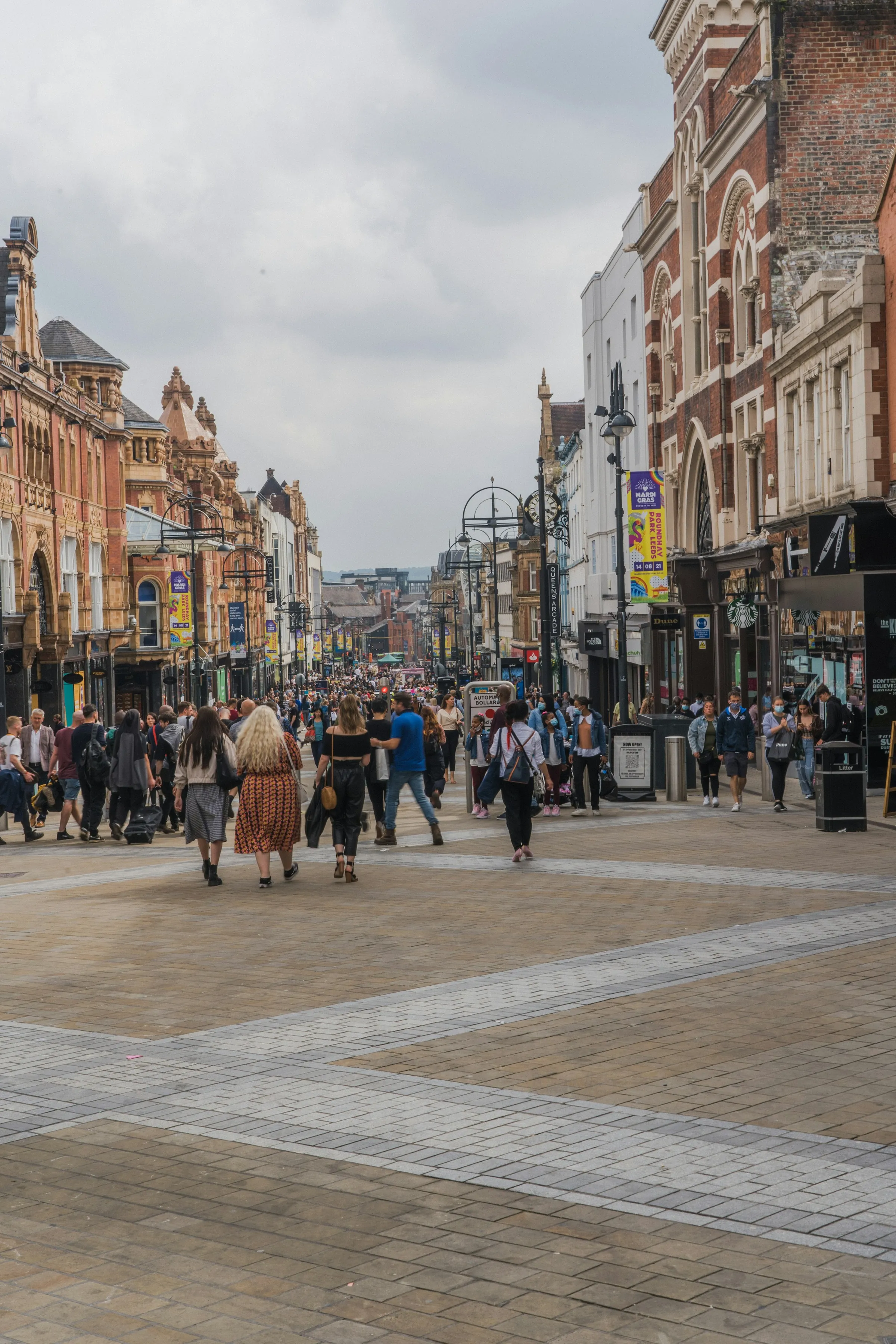 A busy pedestrian high street in an English market town, seen from above