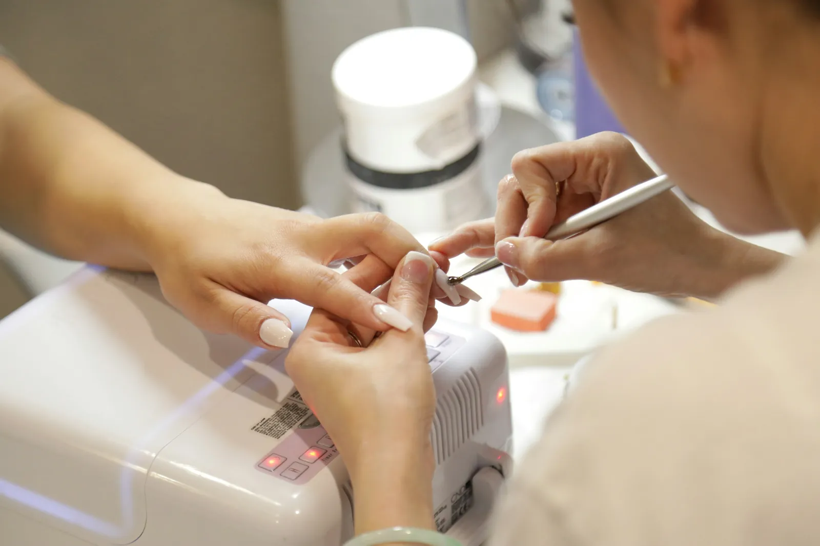A gel manicure in progress at the nail desk