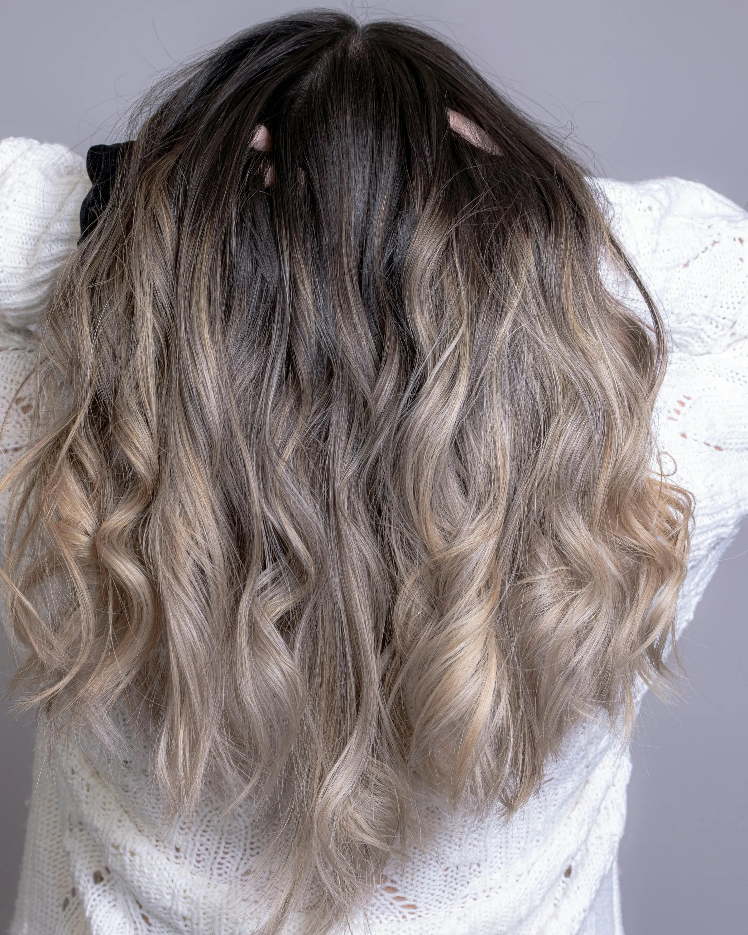 Long silver-blonde hair in loose waves, seen from behind