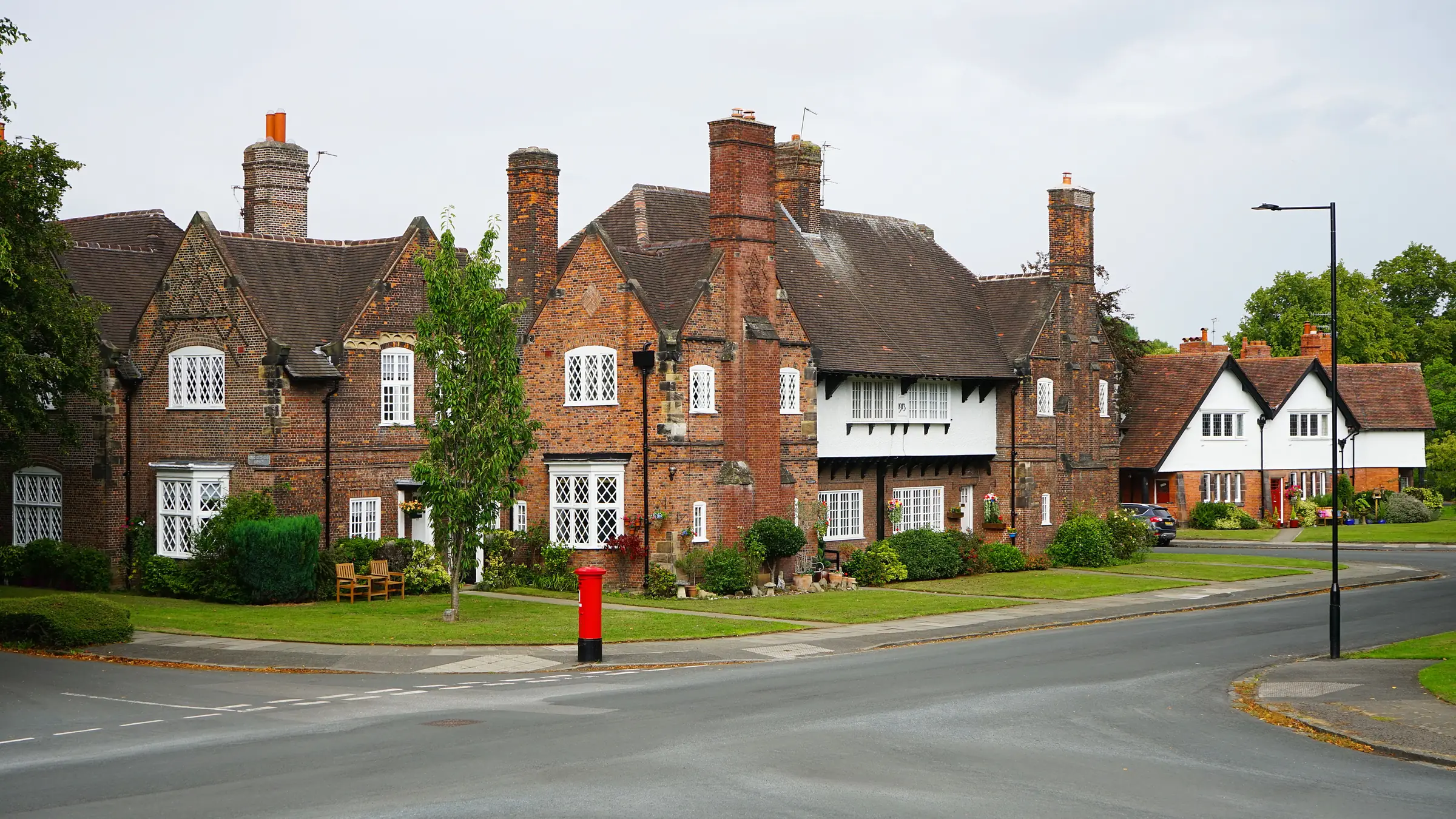 Red-brick houses round the village green, a postbox on the corner