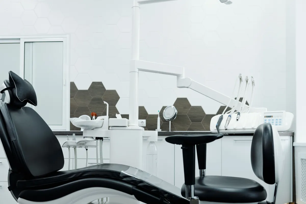 Surgery two: the chair from the side with the hexagon tiled wall behind
