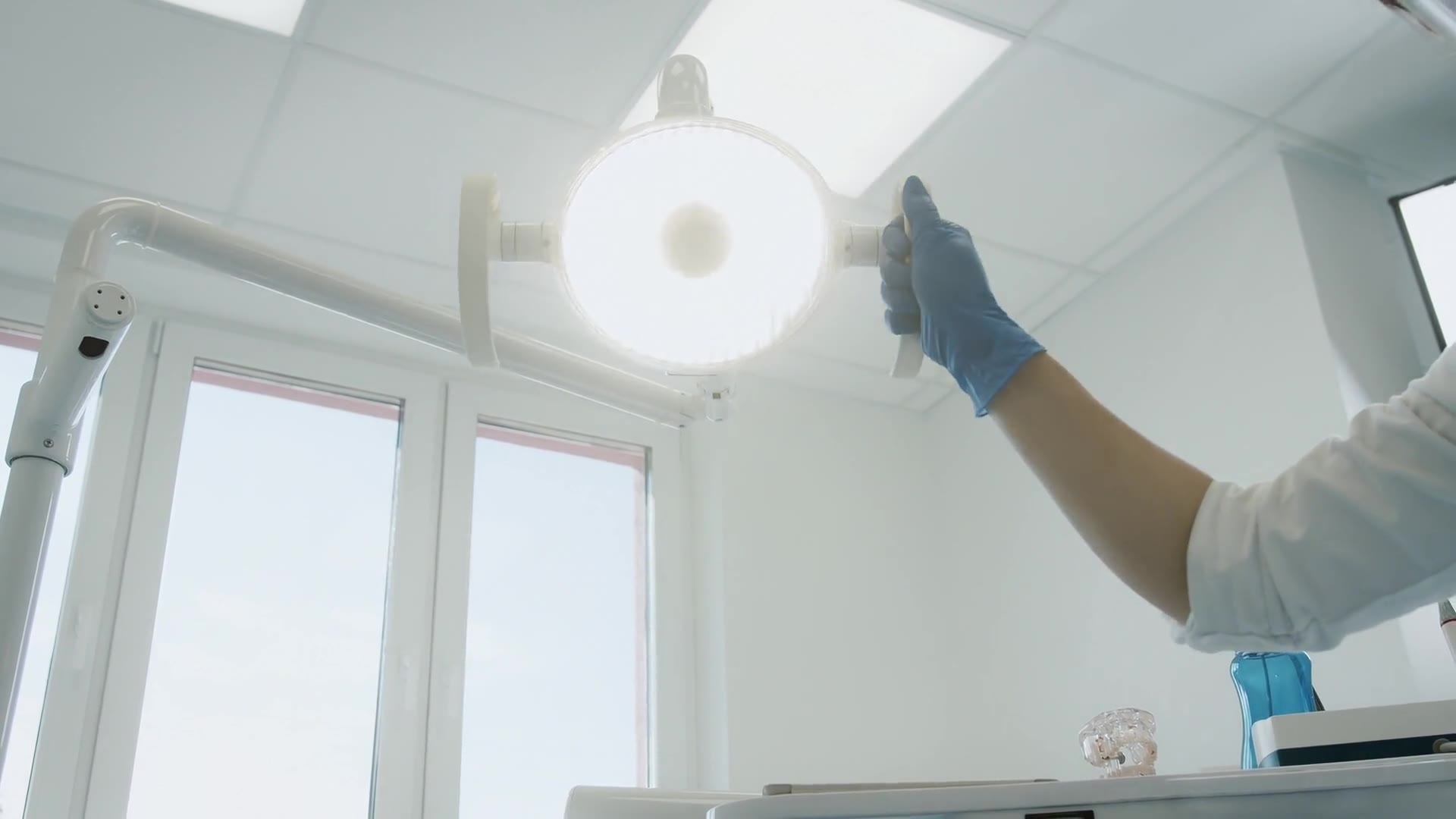A surgery light being switched on above the chair, seen from below